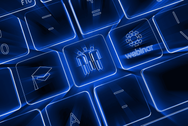 Close-up of a glowing blue computer keyboard with keys featuring icons for people, a graduation cap, and a webinar, symbolizing online learning and collaboration